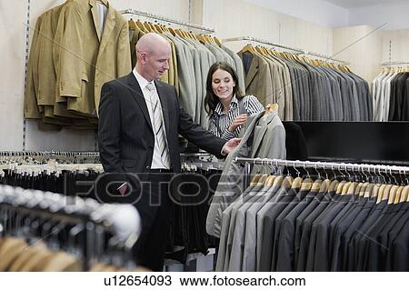 man and woman in clothing store View Large Photo Image Stock Image - man and woman in clothing store. Fotosearch