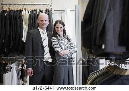 Stock Image - man and woman in clothing store. Fotosearch