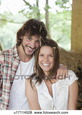Stock Photo - Man and woman in hay barn. Fotosearch