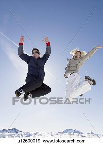man and woman jumping up on mountain View Large Photo Image Stock Photo - man and woman jumping up on mountain. Fotosearch