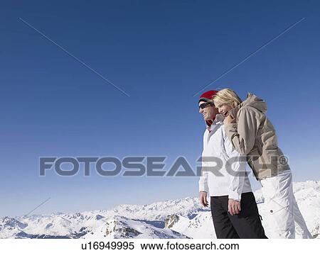 Stock Photography - man and woman looking out from mountain. Fotosearch