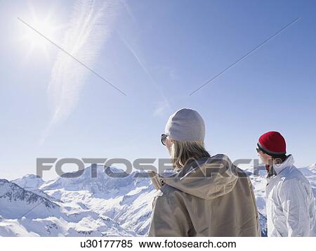 Stock Photography - man and woman looking out from mountain. Fotosearch
