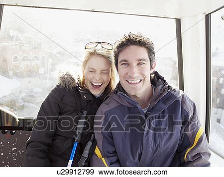man and woman looking out from ski lift View Large Photo Image Stock Photo - man and woman looking out from ski lift. Fotosearch