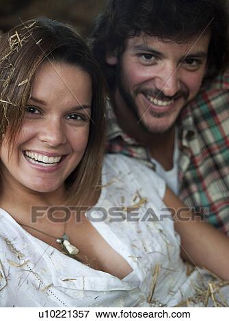 Stock Photo - Man and woman lying in hay. Fotosearch