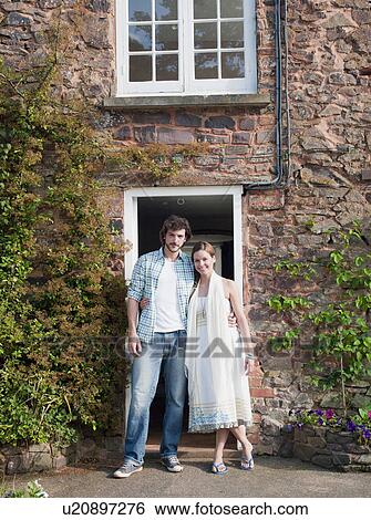 Stock Photograph - Man and woman outside country house. Fotosearch