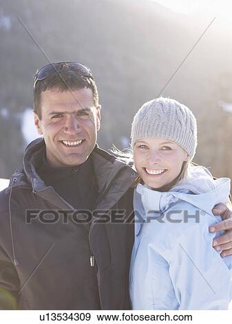 Stock Photo - man and woman portrait on mountain. Fotosearch