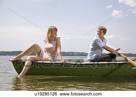 man and woman rowing boat on lake View Large Photo Image Stock Photograph - man and woman rowing boat on lake. Fotosearch