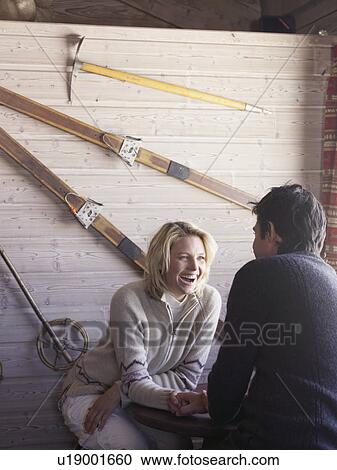 man and woman sitting at ski lodge table View Large Photo Image Stock Image - man and woman sitting at ski lodge table. Fotosearch