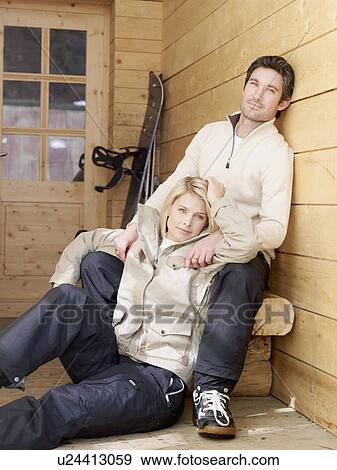 man and woman sitting outside chalet View Large Photo Image Stock Photo - man and woman sitting outside chalet. Fotosearch