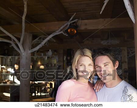 Picture - man and woman smiling in lodge bar. Fotosearch