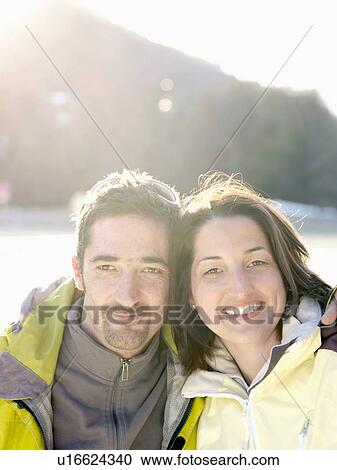 man and woman smiling on snowy hillside View Large Photo Image Stock Image - man and woman smiling on snowy hillside. Fotosearch