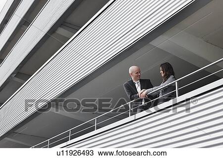man and woman talking in car park View Large Photo Image Stock Image - man and woman talking in car park. Fotosearch