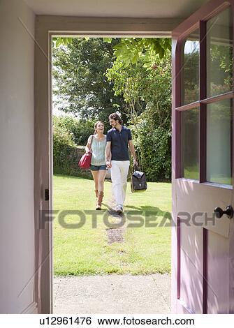 Man and woman walking down garden path View Large Photo Image Stock Photograph - Man and woman walking down garden path. Fotosearch