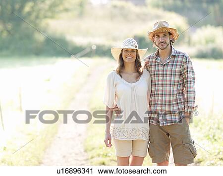 Man and woman walking down lane View Large Photo Image Stock Image - Man and woman walking down lane. Fotosearch