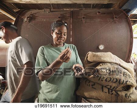 Stock Image - Man And Woman With Coffee Beans. Fotosearch
