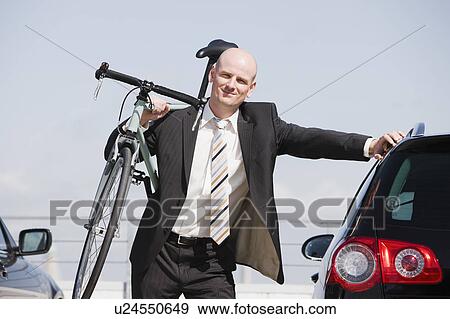 man carrying bike View Large Photo Image Stock Photo - man carrying bike. Fotosearch