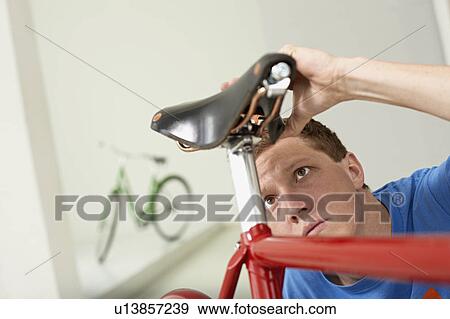 man checking saddle View Large Photo Image Stock Photo - man checking saddle. Fotosearch