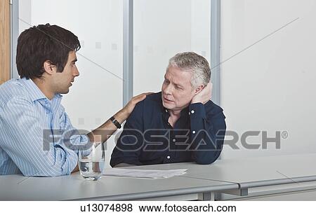 man consoling work colleague View Large Photo Image Stock Photo - man consoling work colleague. Fotosearch