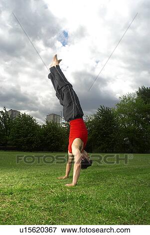 man doing handstand in park View Large Photo Image Stock Photo - man doing handstand in park. Fotosearch