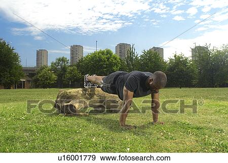 man doing press ups in park View Large Photo Image Stock Photo - man doing press ups in park. Fotosearch