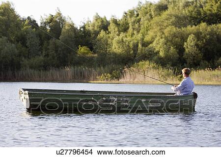 Picture - man fishing in rowboat. Fotosearch
