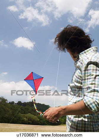 man flying kite View Large Photo Image Stock Image - man flying kite. Fotosearch