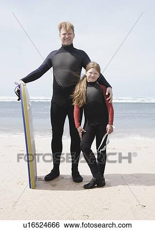 Man & girl wearing wet suits View Large Photo Image Stock Photograph - Man & girl wearing wet suits. Fotosearch