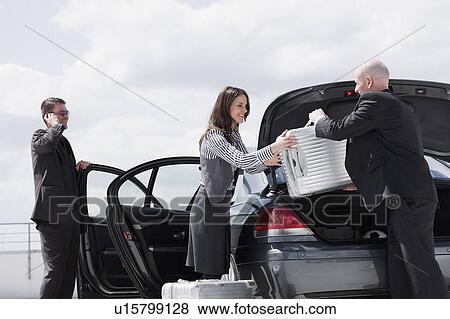 man handing suitcase to woman View Large Photo Image Stock Photo - man handing suitcase to woman. Fotosearch