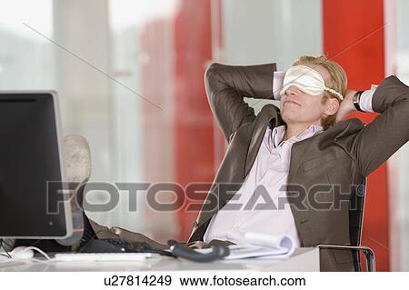 man has a break in an office View Large Photo Image Stock Photo - man has a break in an office. Fotosearch
