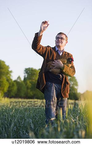 man holding chicken and egg View Large Photo Image Stock Photograph - man holding chicken and egg. Fotosearch