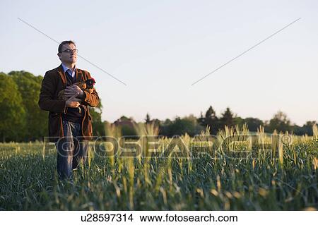 man holding chicken View Large Photo Image Picture - man holding chicken. Fotosearch