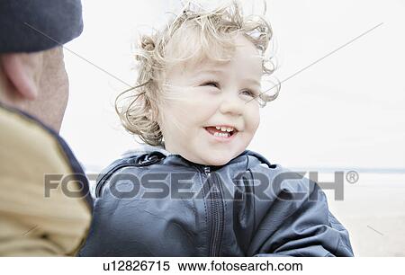 Man holding child on beach View Large Photo Image Stock Photography - Man holding child on beach. Fotosearch