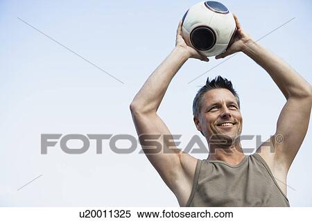 Stock Photography - Man Holding Football. Fotosearch