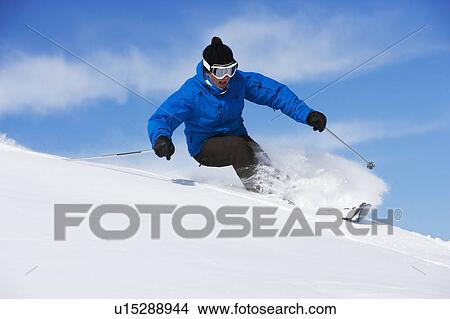 Picture - Man in blue & black outfit turning.. Fotosearch