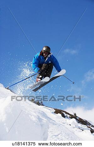 Stock Photography - Man in blue getting air.. Fotosearch