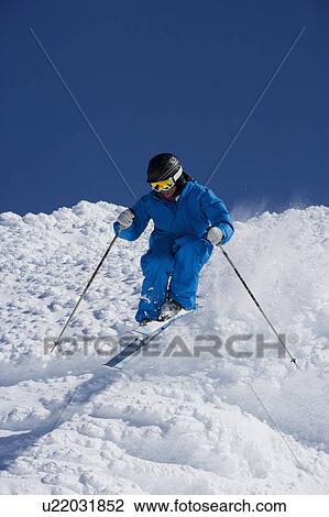Man in blue skiing down hill. View Large Photo Image Stock Image - Man in blue skiing down hill.. Fotosearch