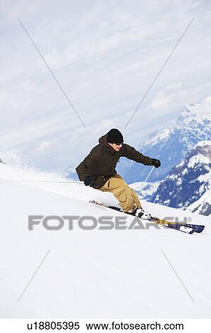 Stock Photography - Man in brown-beige outfit carving.. Fotosearch