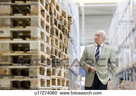 Stock Image - man in charge in storage. Fotosearch