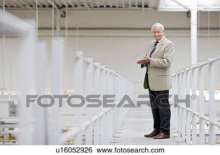 Stock Photograph - man in charge in storage. Fotosearch