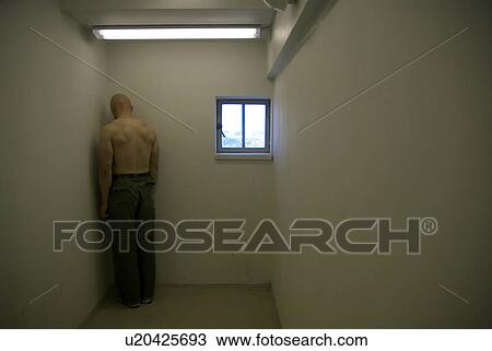 Stock Image - man in corner of room. Fotosearch