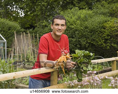 Stock Photo - Man in garden with vegetables. Fotosearch