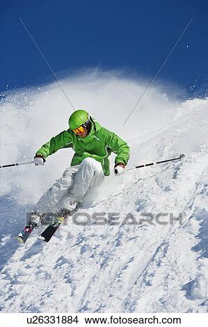 Man in green carving off piste. View Large Photo Image Picture - Man in green carving off piste.. Fotosearch