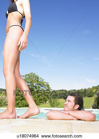 man in pool admiring young woman View Large Photo Image Picture - man in pool admiring young woman. Fotosearch