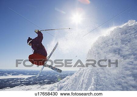 Stock Image - Man in purple getting air-time.. Fotosearch
