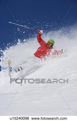 Stock Photo - Man in red falling mid carve off-piste.. Fotosearch