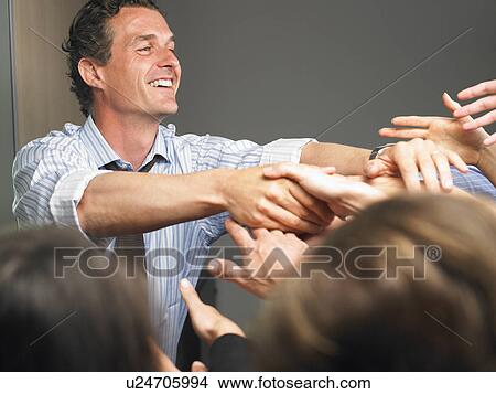 Man in the crowd, shaking people's hands View Large Photo Image Picture - Man in the crowd, shaking people's hands. Fotosearch