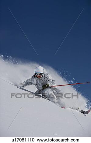 Stock Image - Man in white & grey suit powder-turn.. Fotosearch