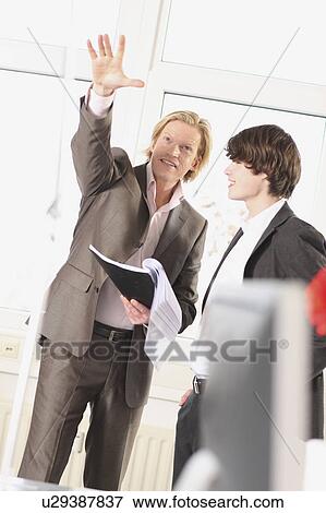 man is teaching something to a trainee View Large Photo Image Stock Photo - man is teaching something to a trainee. Fotosearch