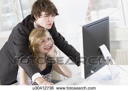 man is teaching something to a woman View Large Photo Image Stock Photograph - man is teaching something to a woman. Fotosearch