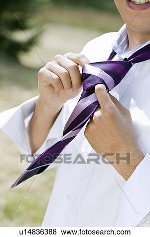 man knotting tie View Large Photo Image Stock Photo - man knotting tie. Fotosearch